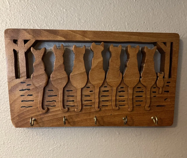 Wooden hand carved cats on a fence wall mounted key holder