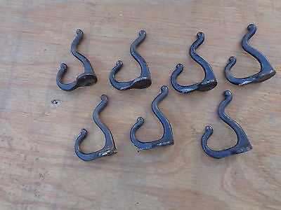 Seven (7) Matching Solid Cast Iron Coat Hooks