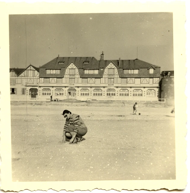Portrait of young woman squatting on the beach - antique photo 1954