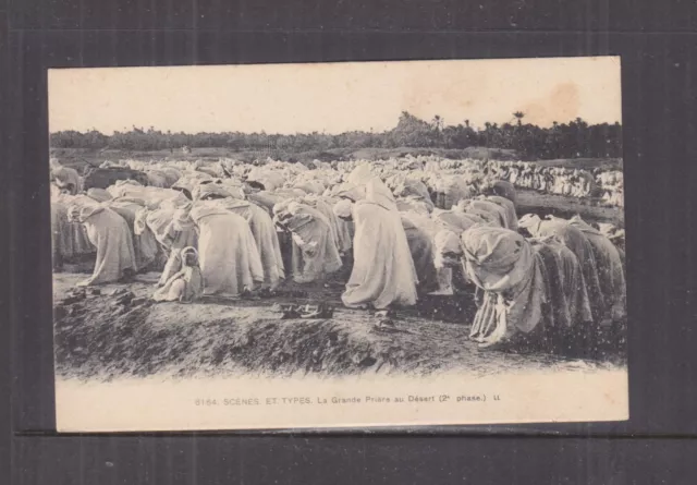 NORTH AFRICA, PRAYING IN THE DESERT, 1930 ppc., unused.