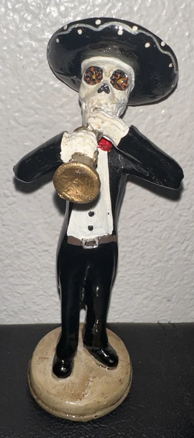 day of the dead figurine playing trumpet