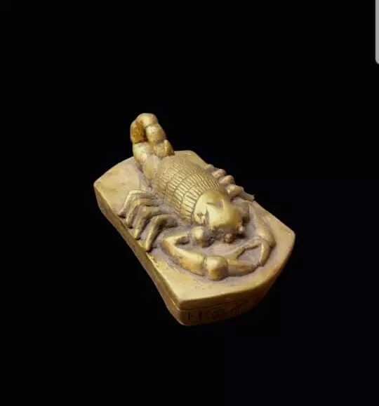 An antique stone statue of an ancient Egyptian scorpion, hand-carved in Egypt