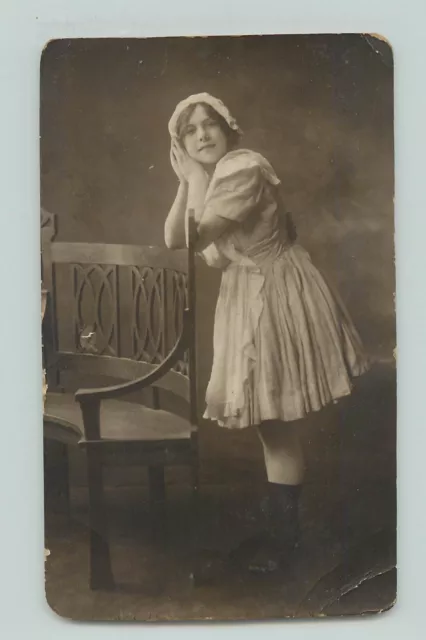 POSTCARD Young Girl. Studio portrait. apron bonnet. RPPC