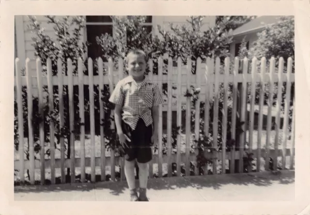 Old Photo Snapshot Boy Smiling Standing In Front Fence Vintage Portrait 3A9