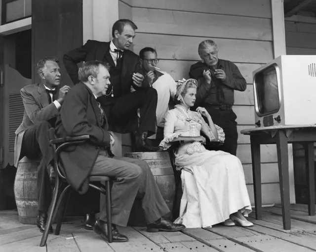 Grace Kelly Gary Cooper cast watching vintage TV on High Noon movie set Photo