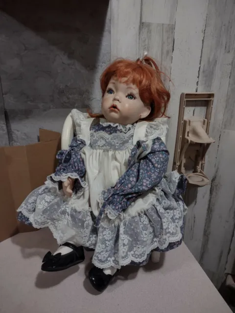 Porcelain Doll Sitting In Wood Chair