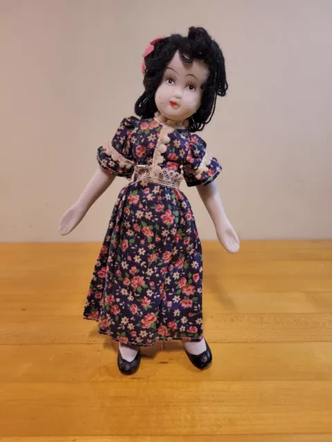 9 inch Posable vintage bisque porcelain doll with black yarn hair w metal stand