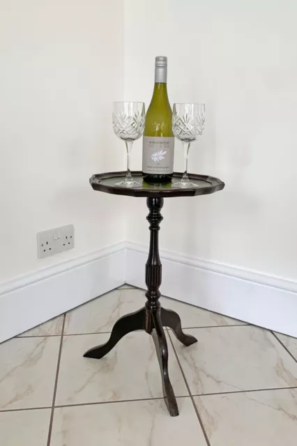 Dark Wood Tripod-Based Wine Table With Green Leather Inlay.