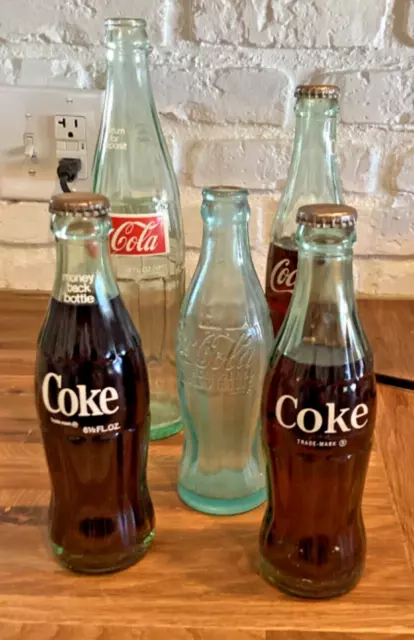 Vintage coca cola bottles, Some still have coke in them never been opened Qty 5