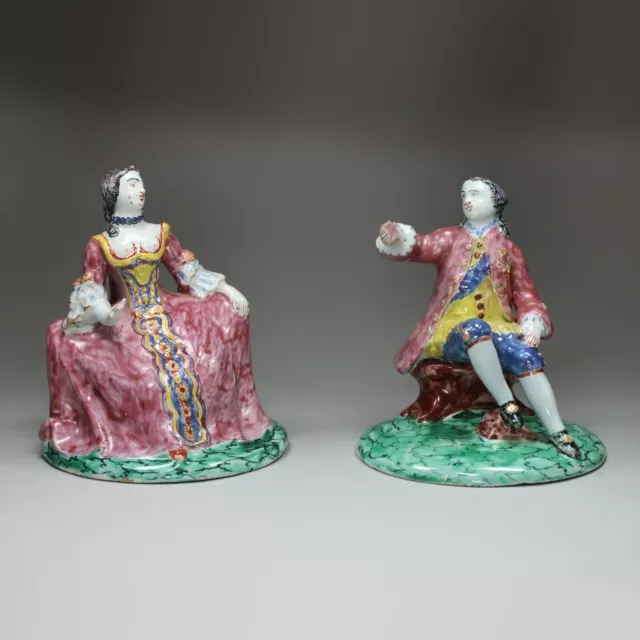 Pair of Delft polychrome figures of a seated man and woman, early 18th century