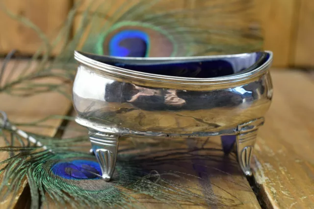 Condiment dish in Sterling Silver, oval/boat shaped and lined with blue glass