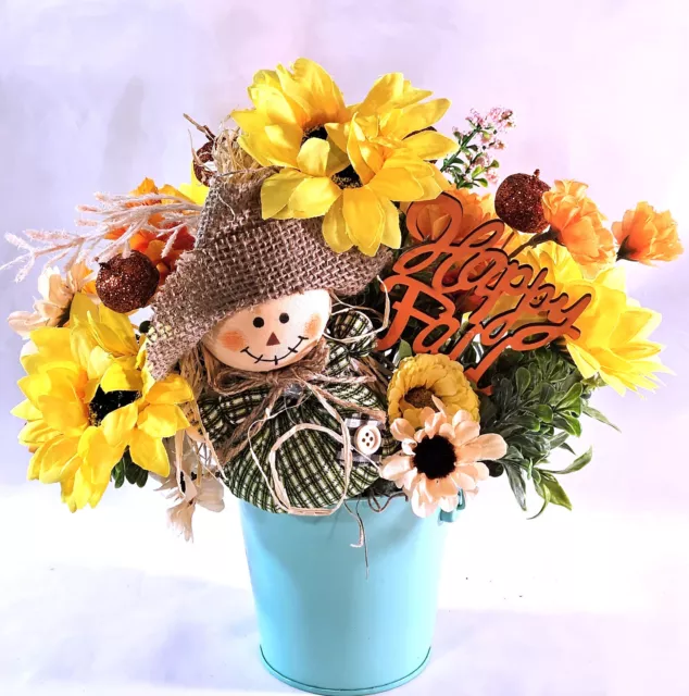 Adorable Scarecrow, Green Attire sitting in Fall Autumn Sunflower Patch