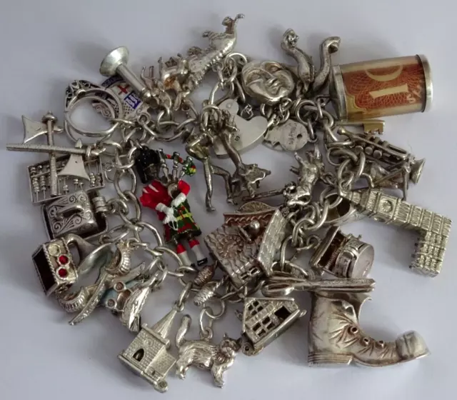 Vintage heavy solid silver charm bracelet & 31 silver charms inc opening,moving