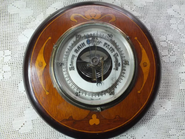 7 inch vintage barometer. Wood inlay surround.