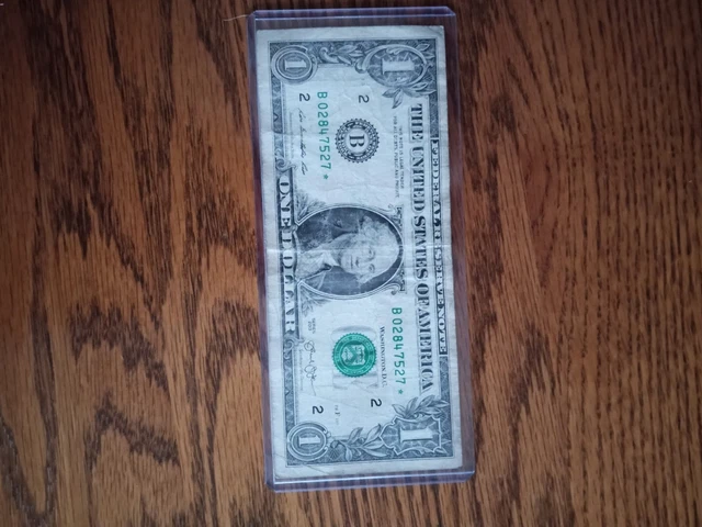 Star Note, 2013 one dollar bill well circulated with wrinkles and one small cut