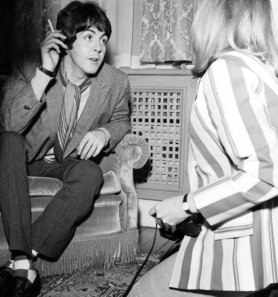 PAUL MCCARTNEY CHATS to American photographer Linda Eastman at the Old
