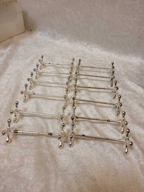 Nr. 279) 12 antike WMF Messerbänkchen