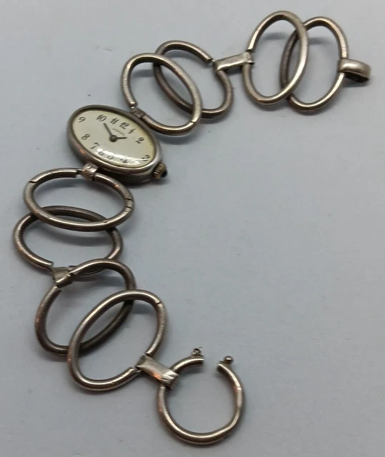 Montre ancienne à gousset pour femme, en argent, poinçon au Crabe. Arrière boîtier à motif floral gravé - Montres & Bijoux
