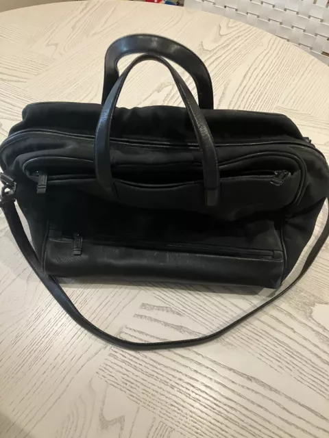 TUMI carry on black leather/ballistic nylon luggage/bag