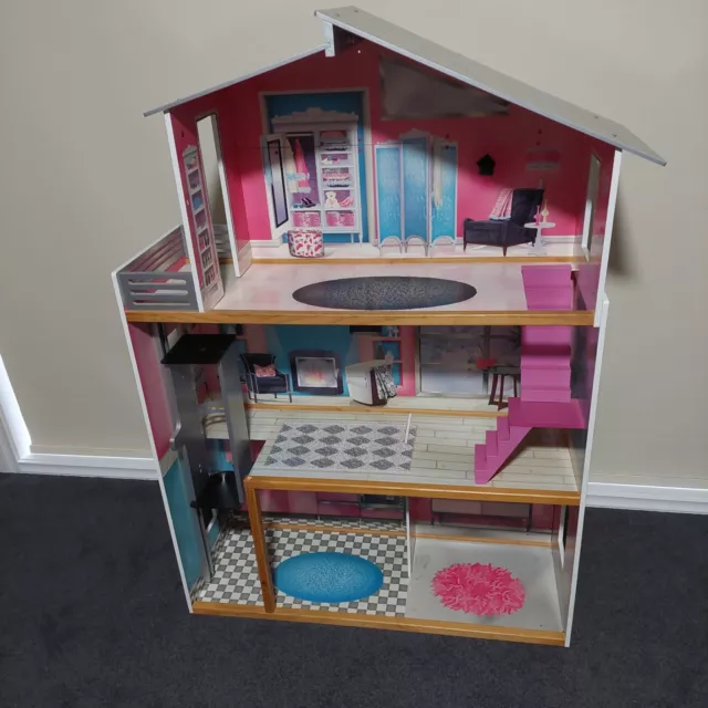 dolls house pink with furniture and Barbie car