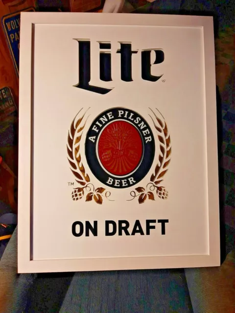 miller lite "on draft" mirror. and miller lite tin sign 2 pack..local pick up