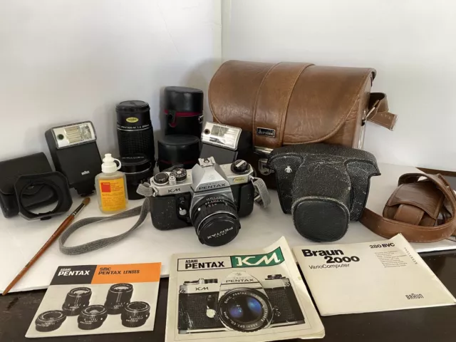 Pentax Asahi KM 35mm SLR Camera With 2 Pentax Lenses, Lens Hood & 2 Braun flash