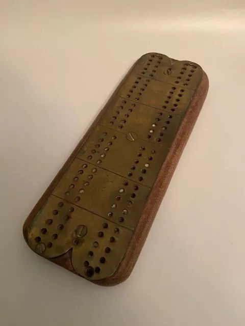 Vintage brass cribbage board with wooden base