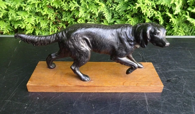 Perro metal sobre base de madera