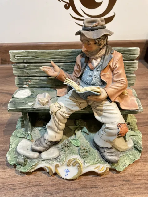 Beautiful Capodimonte Figurine Of A Tramp Reading On A Bench. Signed By Artist