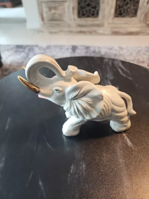 https://www.picclickimg.com/X2QAAOSwgORlCels/Vtg-Ceramic-Porcelain-white-Elephant-Figurine-statue-with-gold.webp