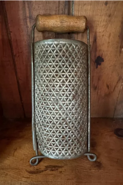https://www.picclickimg.com/X2YAAOSwCrBkwXmL/Antique-Punched-Tin-Half-Round-Grater-Wooden-Handle.webp