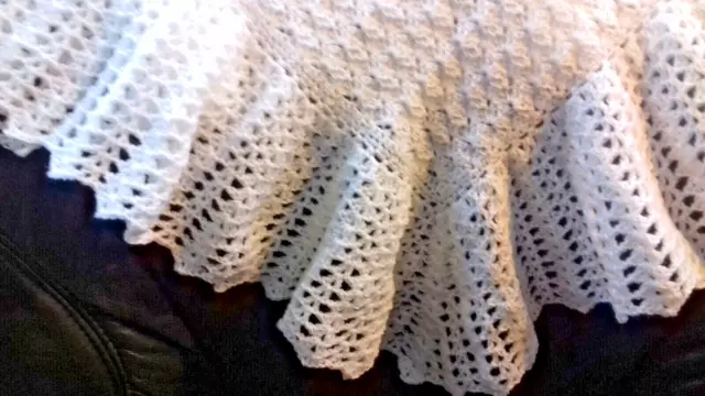 A hand crocheted White 3 ply baby Shawl 3