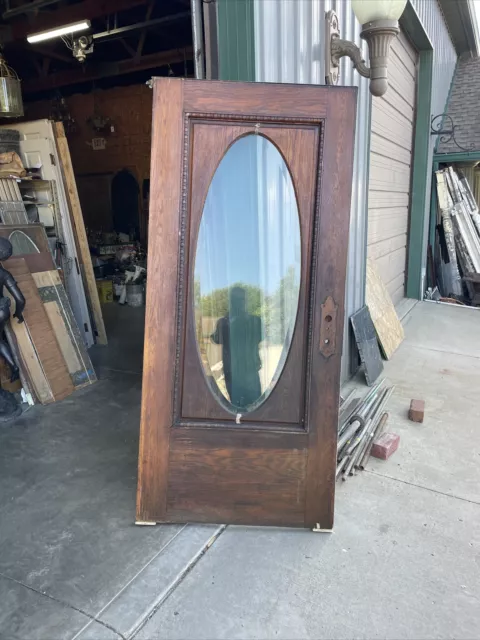 AN 716 antique oak beveled glass oval entrance door 37.75 X83.25