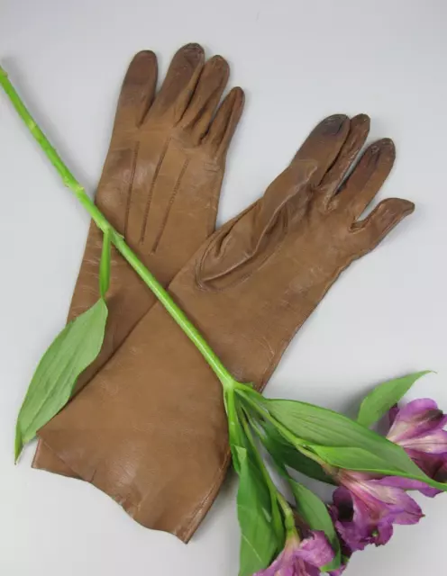 Pair of 1950's vintage ladies gloves.  Thin brown leather. Mid-length. Small.