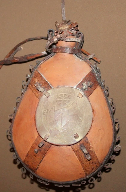Vintage hand made redware pottery flask with leather ornaments