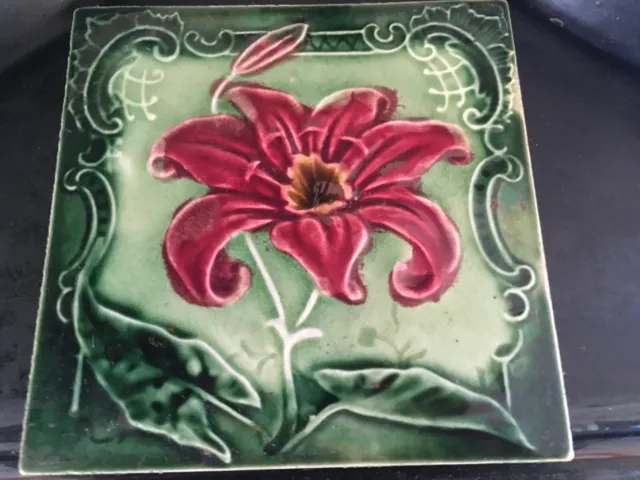 Antique ceramic tile Lily plant with rococo border , green/red