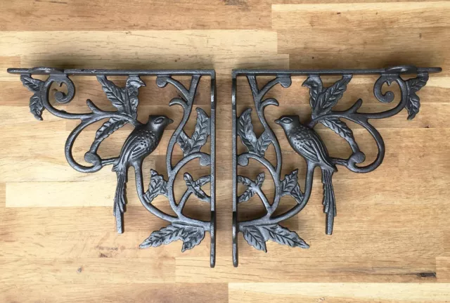 A pair of antique Victorian exotic bird brackets cast iron shelf bracket