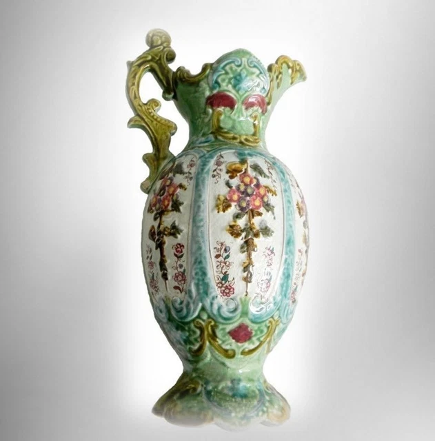 Majolica large art pottery green ewer with floral panels and decorative handle