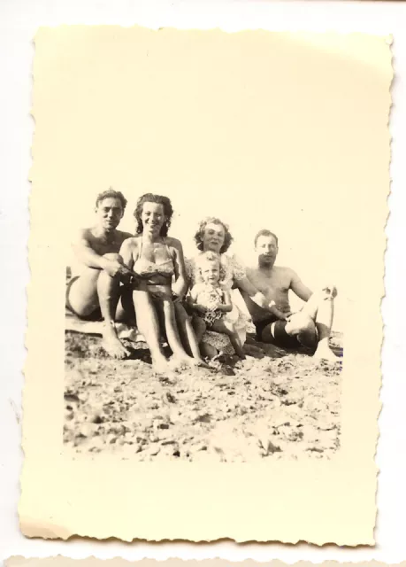 Family on the beach sitting ds le sand - antique amateur photo year. 1940
