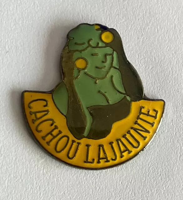 21 - Pin's BOITE DE CACHOU LAJAUNIE - FEMME AVEC 1 BOITE DANS CHAQUE MAIN