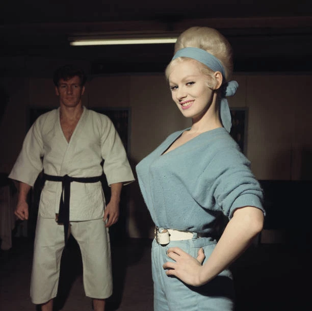 BRITISH GLAMOUR MODEL & actress Sabrina wearing a blue jumpsuit 1964