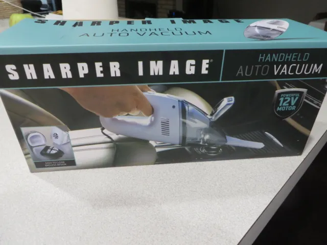 NEW IN BOX;   sharper image handheld auto vacuum-BAGLESS DESIGN 12V POWER