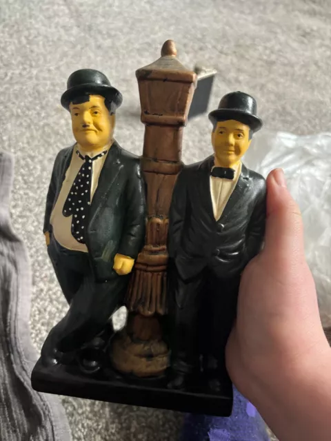 laurel and hardy figures standing at lights