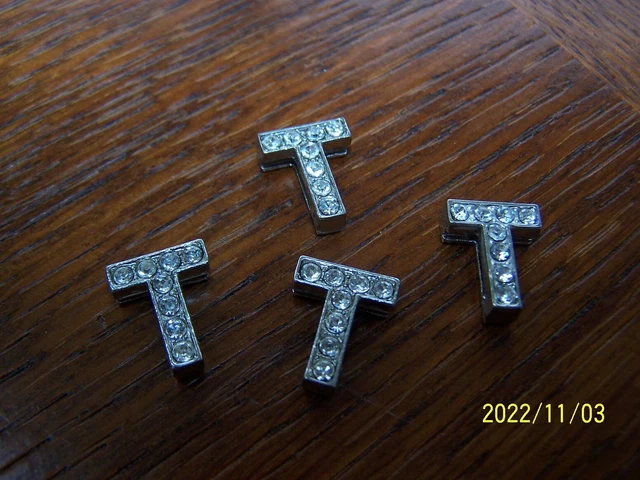 Bouton ancien en strass sur métal argenté en forme de lettre. Lettre T. Réf 413