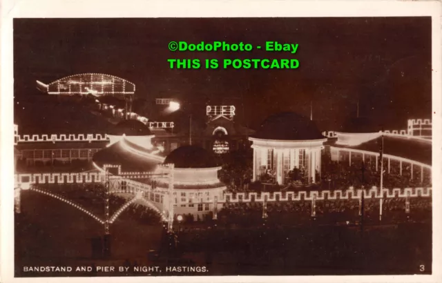 R339966 Bandstand And Pier By Night Hastings. 3. RP. Post Card