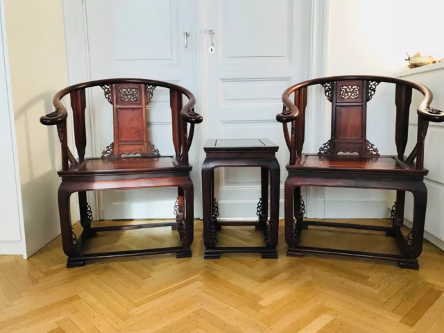 Chinese traditional carved warm elmwood 'king and queen' chairs and table.