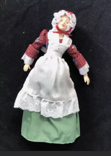 Vintage Avon Reproduction porcelain doll In early American costume .