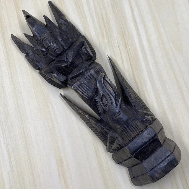 Hand carved dark wooden sculpture face & pointed detail to top animal at bottom