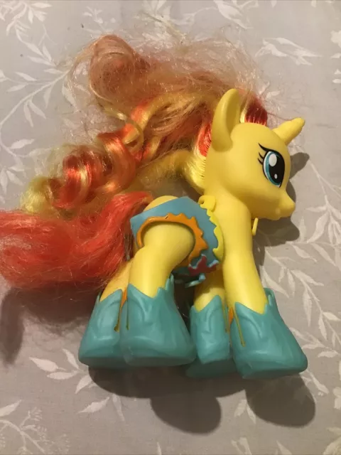 my little pony yellow horse with yellow and orange streaked hair and wearing sho