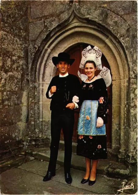 CPM Couple en costumes devant le porche de l'Église FOLKLORE (753242)